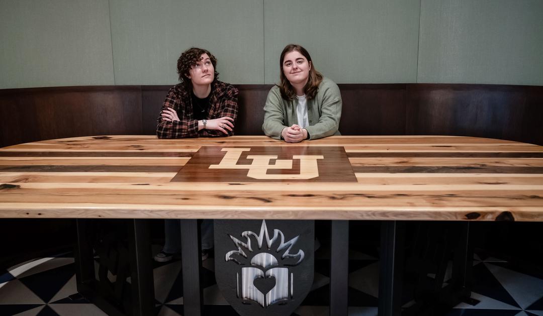Students pose at the pub table they helped create at Mountaintop