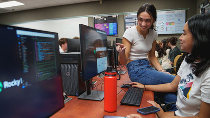 Students looking at a computer screen together